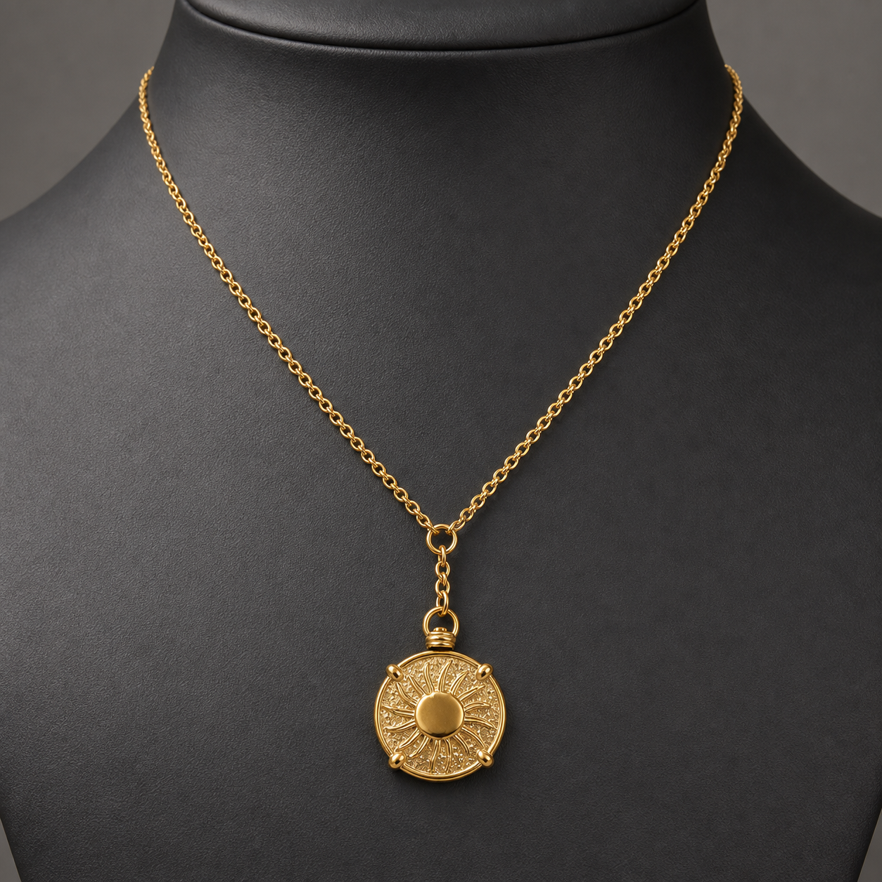 Hammered antique gold coin pendant necklace on charcoal jewelry bust