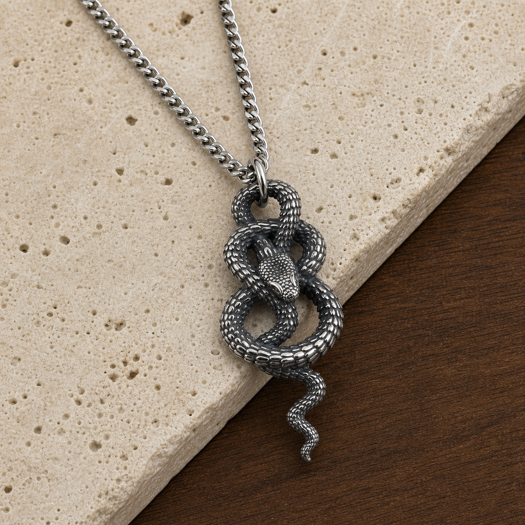 Coiled snake pendant necklace styled on travertine and walnut