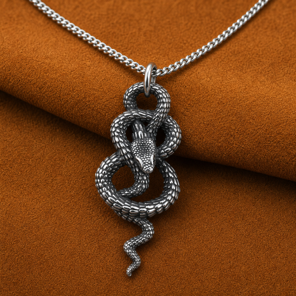 Coiled snake pendant necklace styled on burnt ochre suede