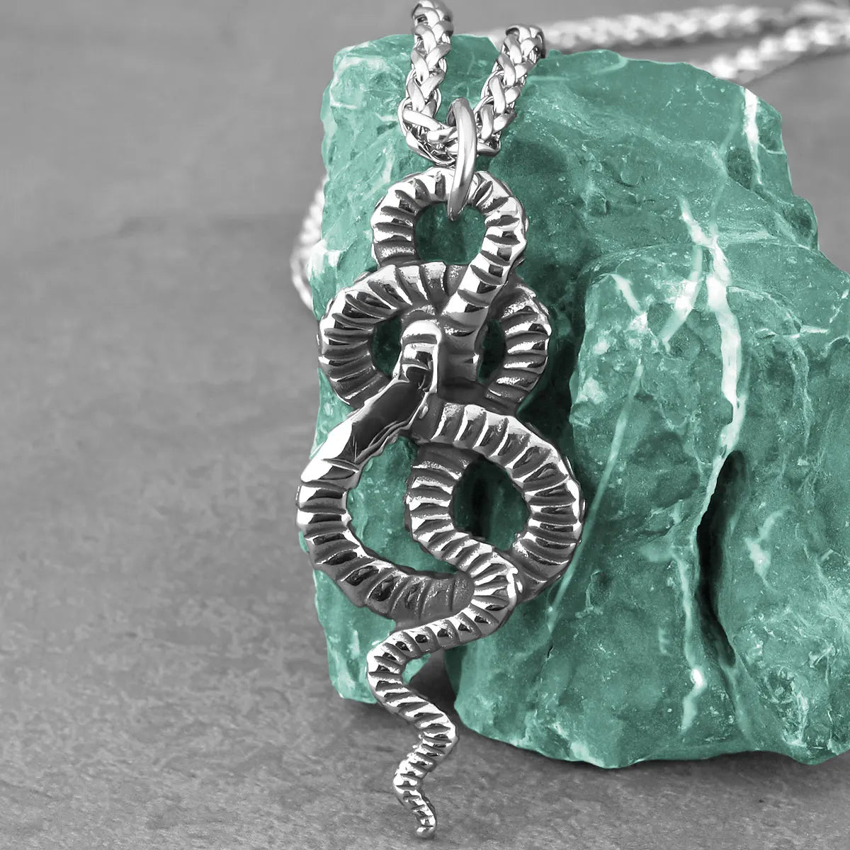 Original close-up of the coiled snake pendant texture