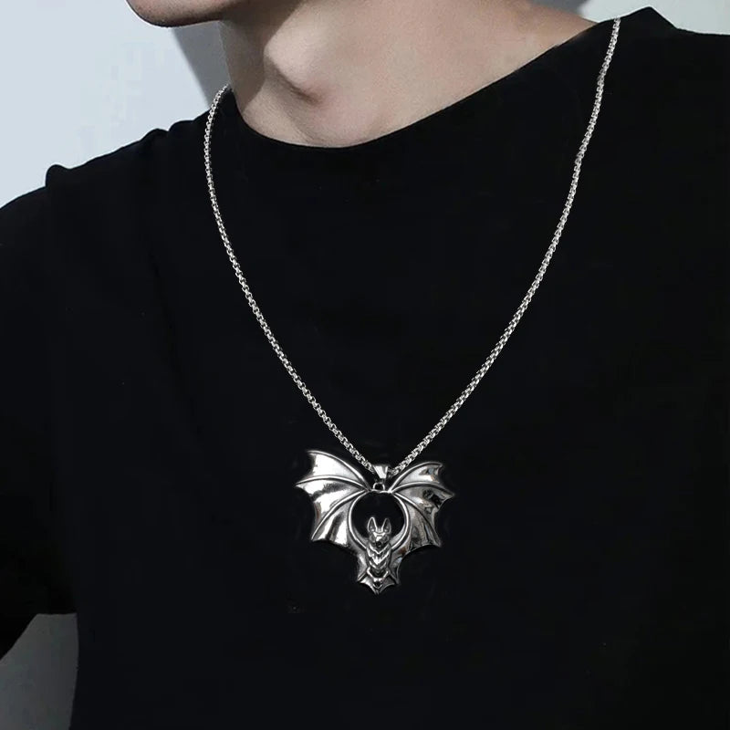 Original listing image showing the flying bat pendant necklace worn with a black shirt