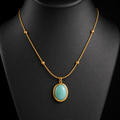Green stone oval pendant necklace on charcoal bust