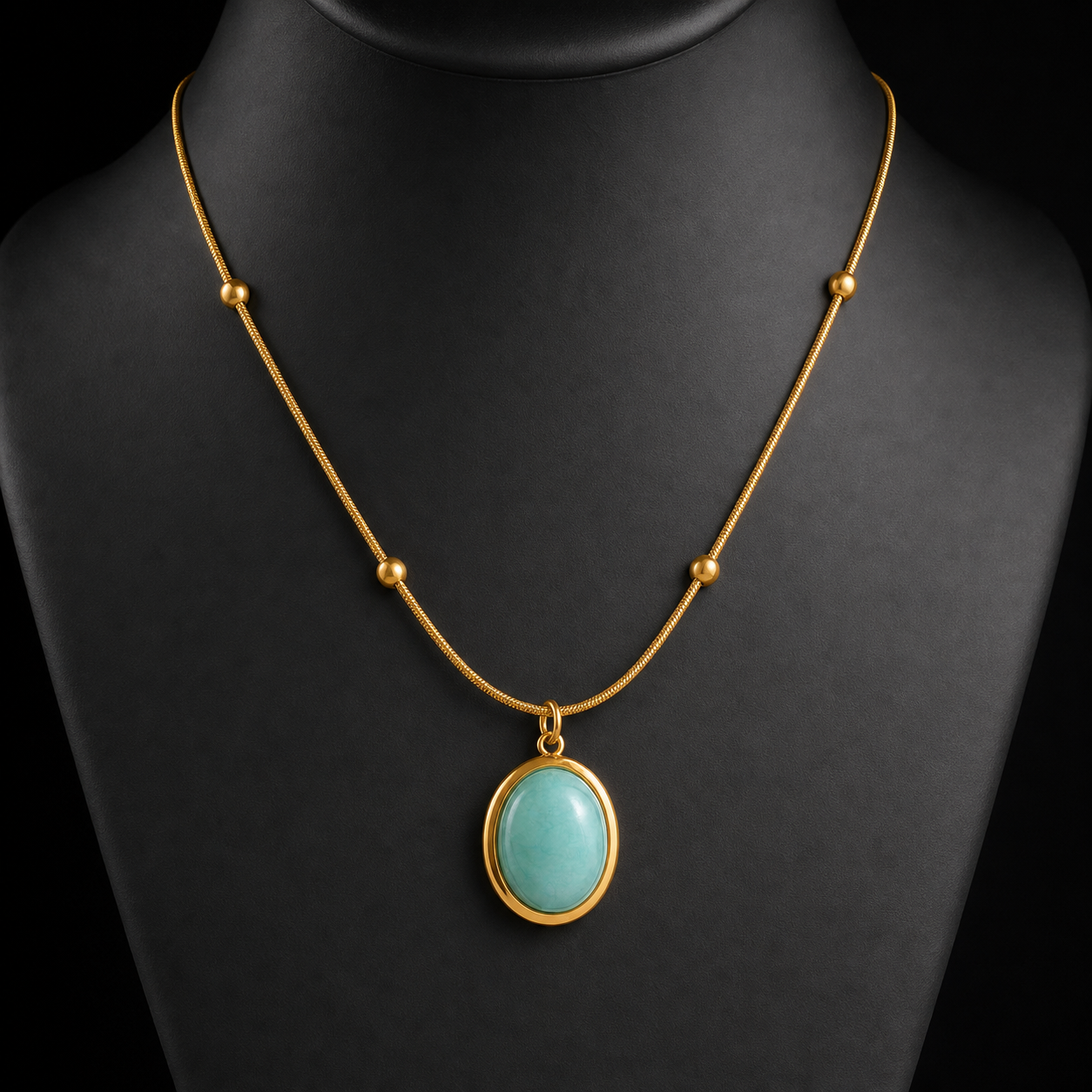 Green stone oval pendant necklace on charcoal bust