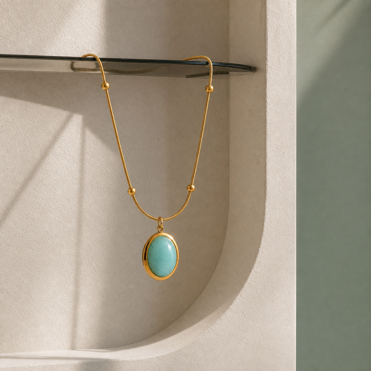Green stone oval pendant necklace in an ivory plaster niche