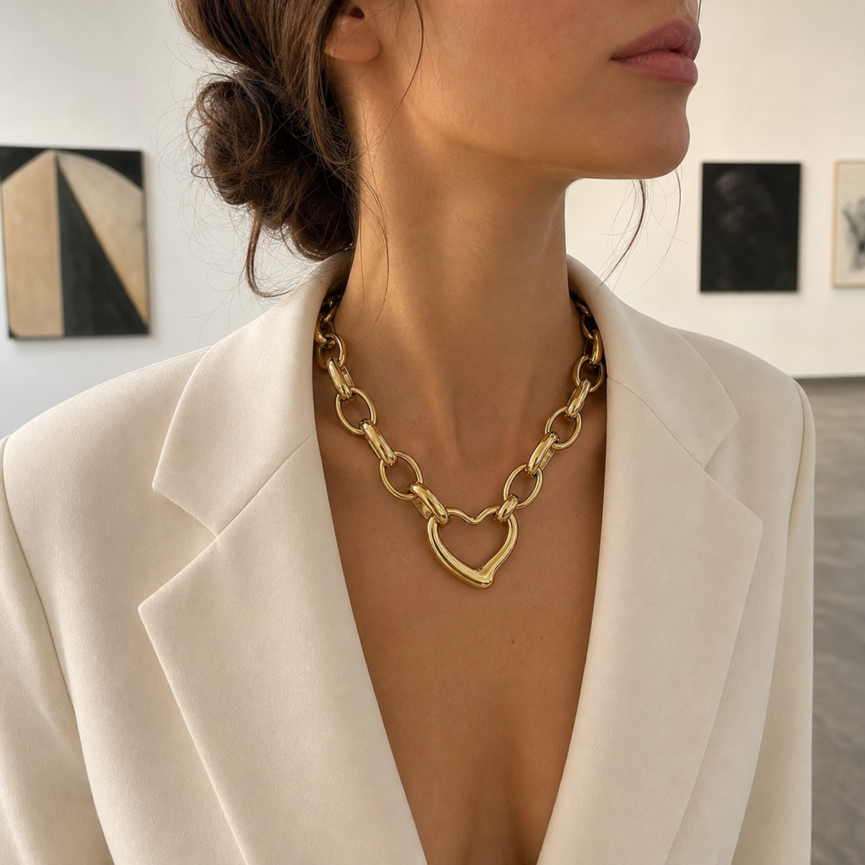Irregular heart link-chain necklace worn with ivory blazer