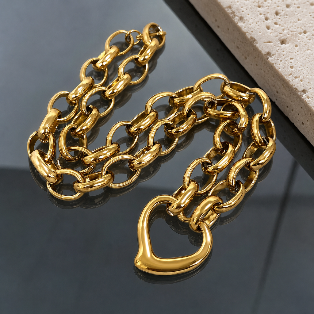 Irregular heart link-chain necklace on smoked glass and travertine