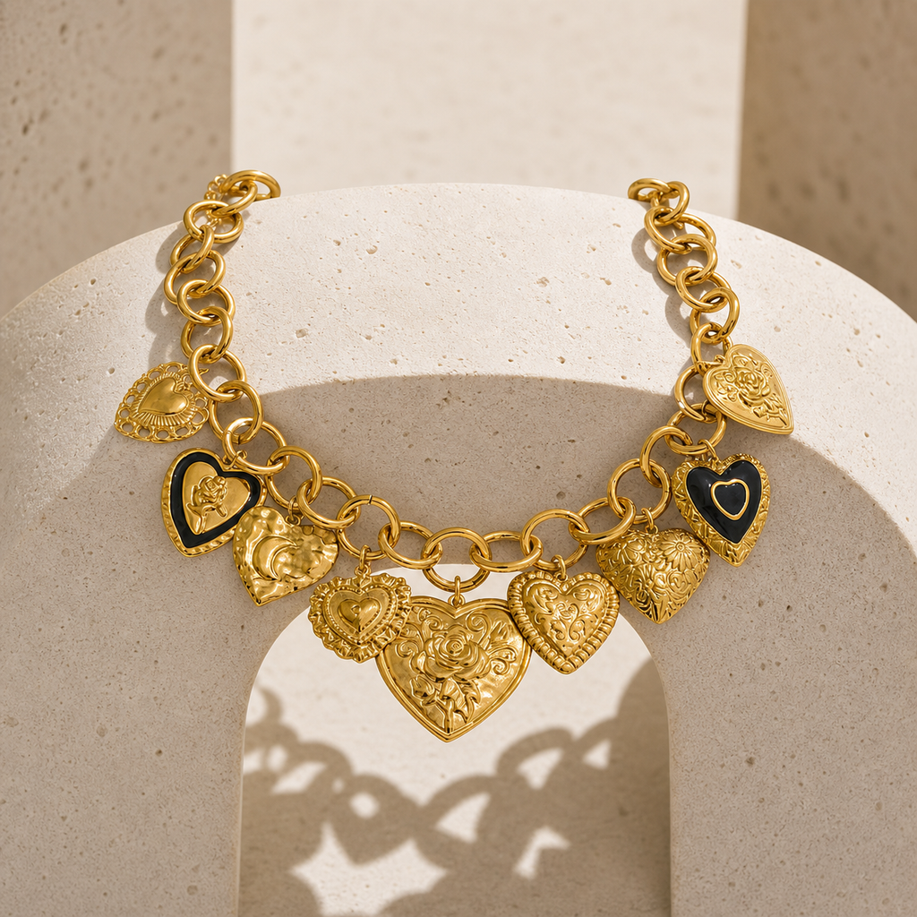 Gold multi-heart charm statement necklace on a travertine arch display