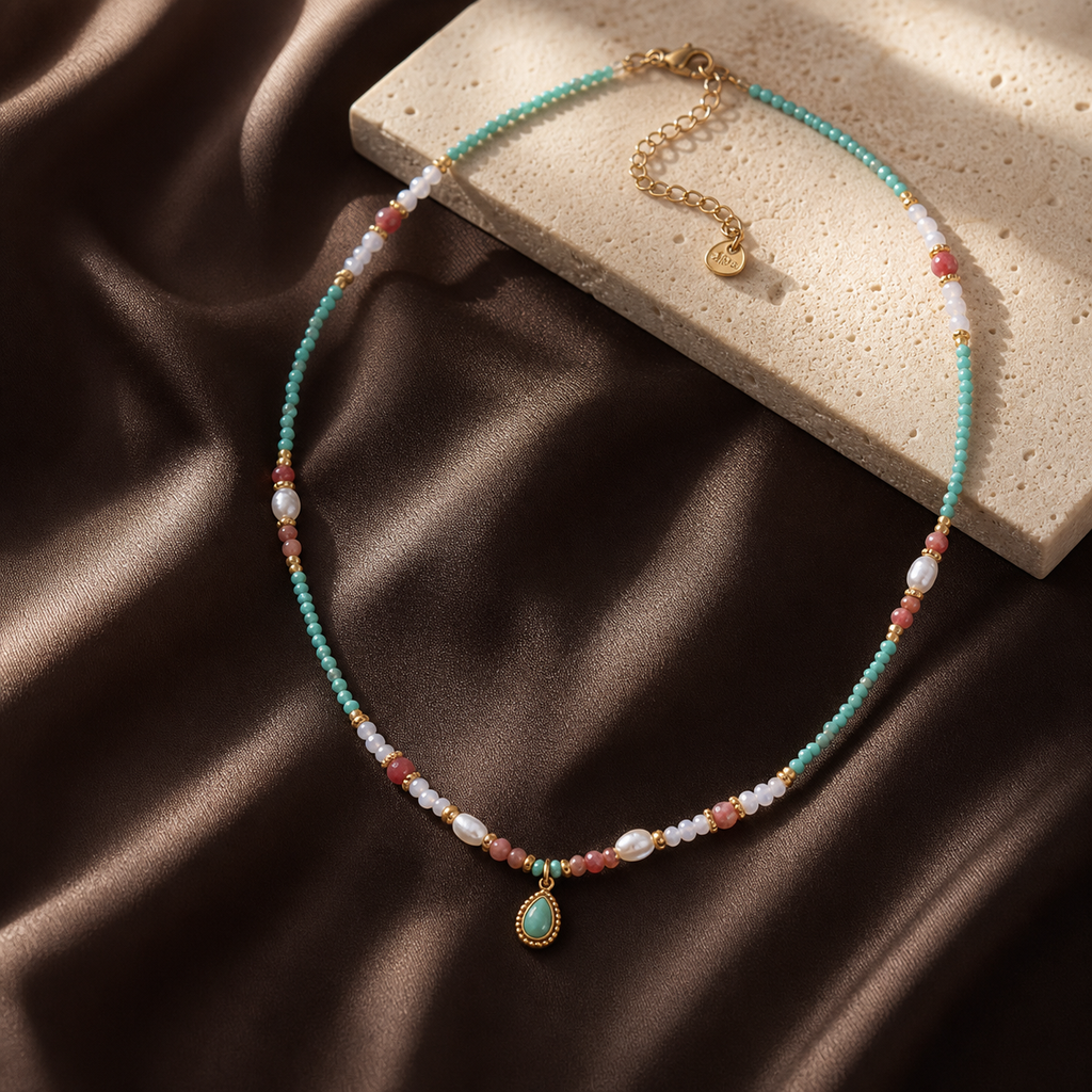 Natural-stone pearl waterdrop necklace on espresso silk and travertine