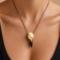 Gothic raven skull pendant necklace shown at scale on a model