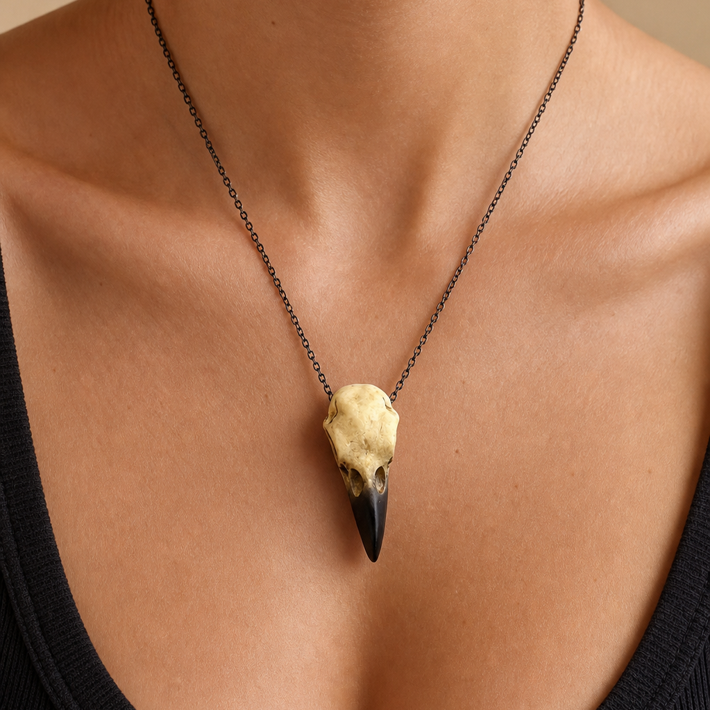 Gothic raven skull pendant necklace shown at scale on a model