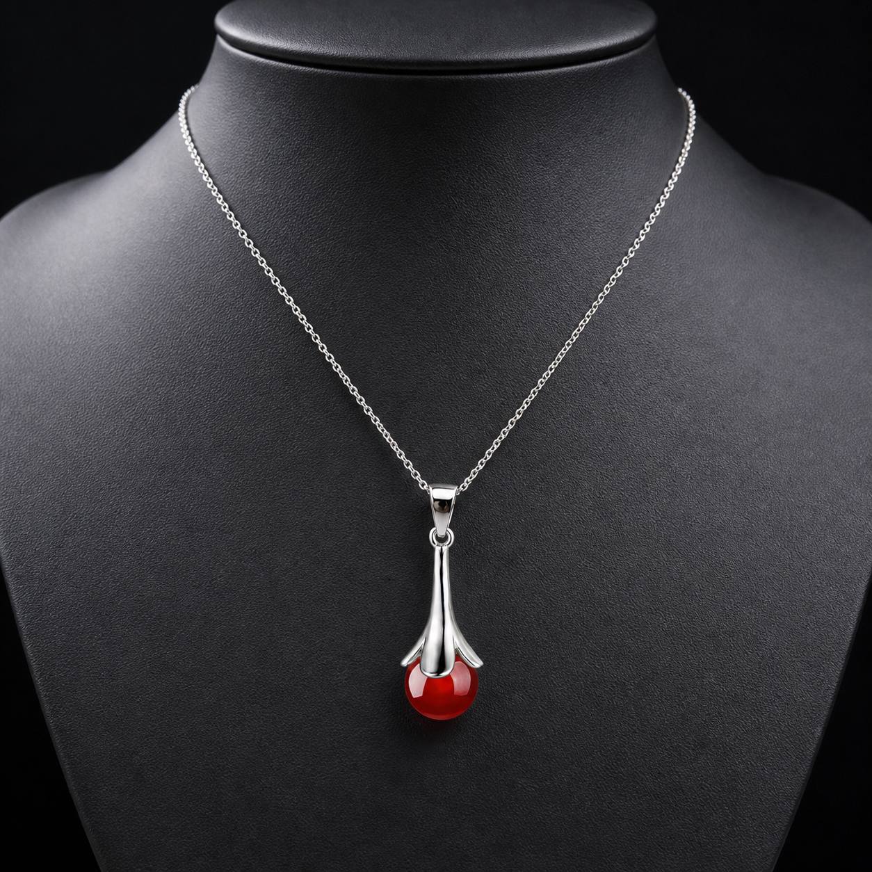 Red agate drop pendant necklace on charcoal bust