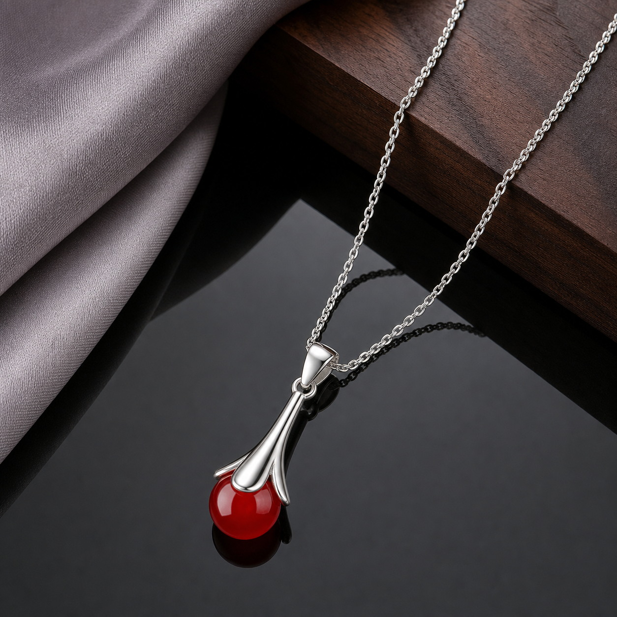 Red agate drop pendant necklace on smoked glass
