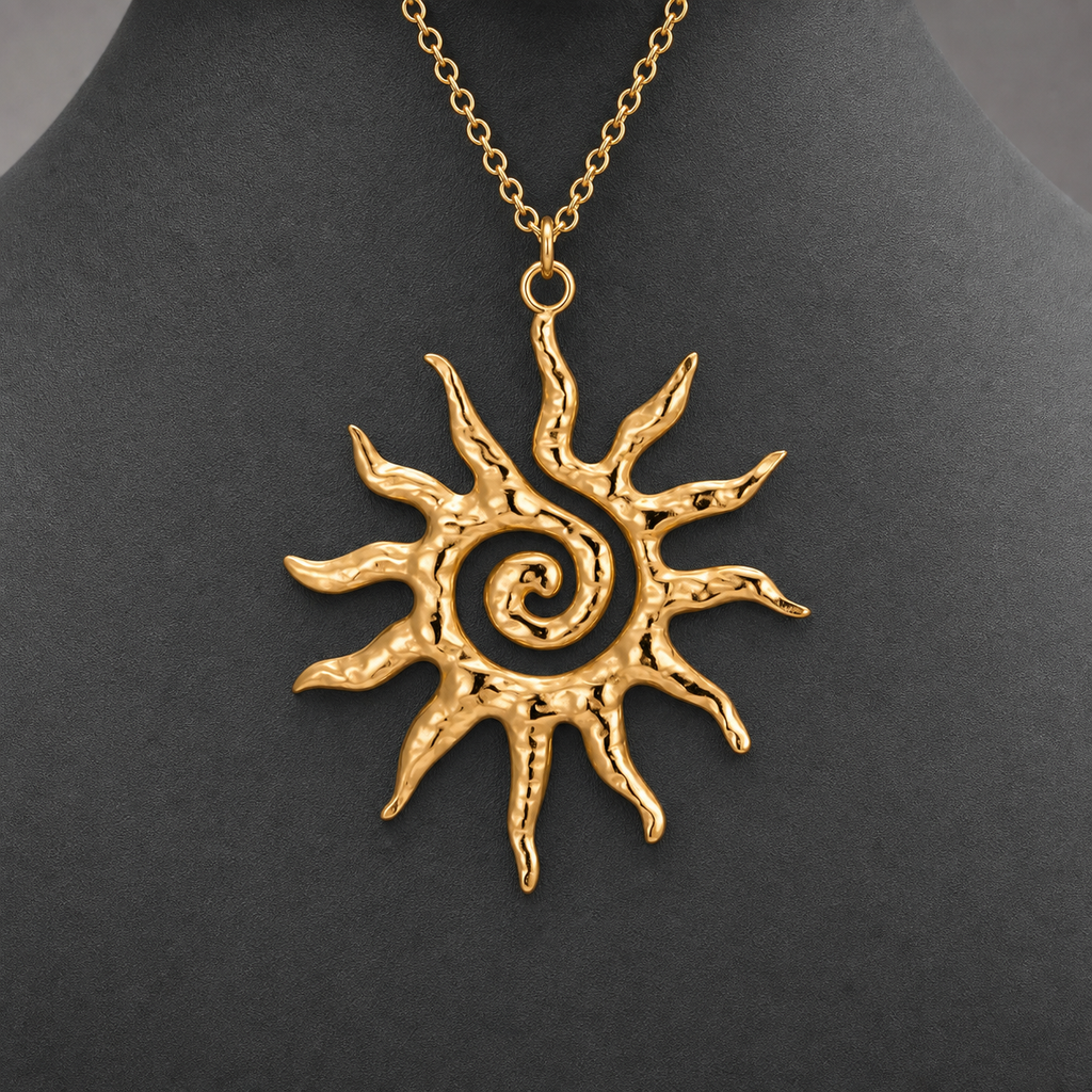 Gold textured spiral sun pendant necklace on charcoal jewelry bust