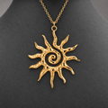 Gold textured spiral sun pendant necklace on charcoal jewelry bust