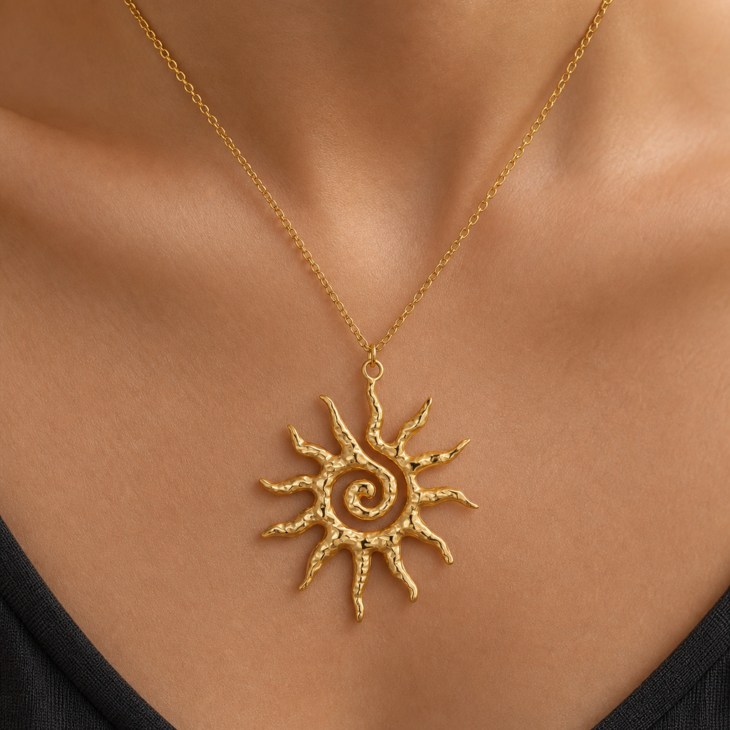 Gold textured spiral sun pendant necklace worn on model