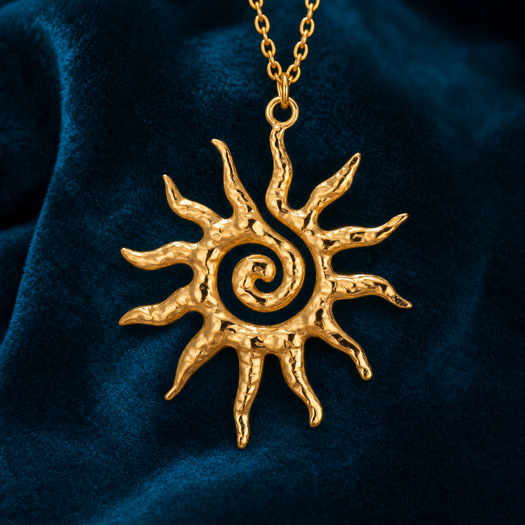 Gold textured spiral sun pendant necklace on petrol-blue velvet