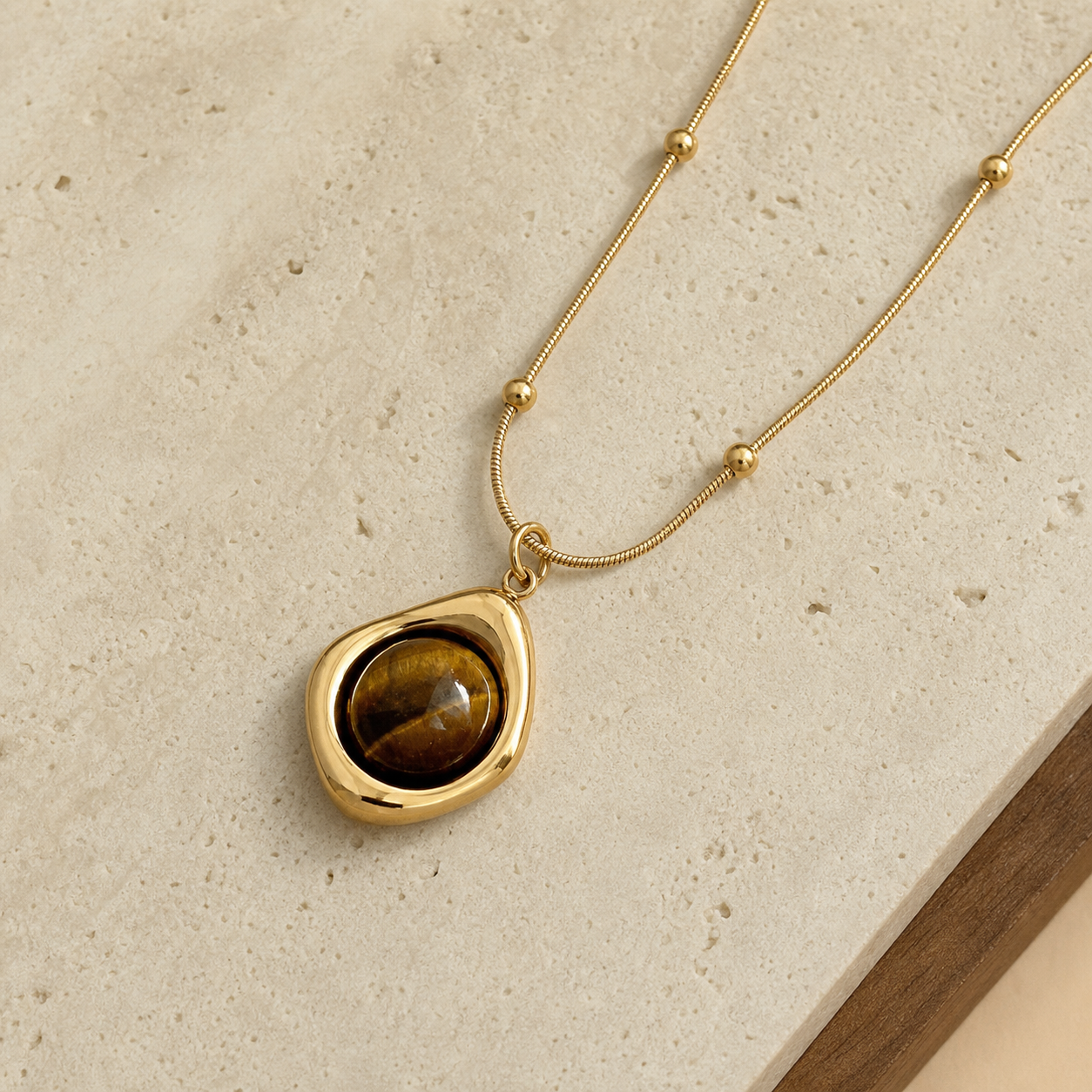 Tiger-eye pendant on travertine and walnut